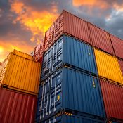 Stacked shipping containers in vibrant colors contrast with a dramatic sunset sky. the image showcases industrial cargo operations, emphasizing logistics, global trade, and transportation under dynamic lighting conditions. Generative AI